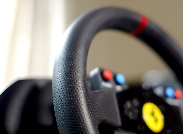 Close-up of Thrustmaster T300 GTE racing wheel.