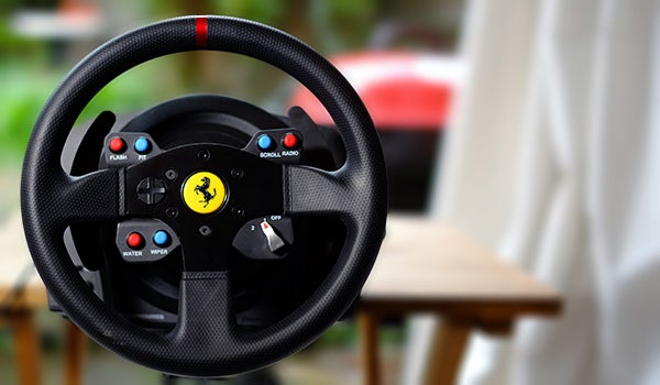 Thrustmaster T300 GTE racing wheel with Ferrari logo.