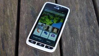 Doro Liberto 820 smartphone on wooden surface.