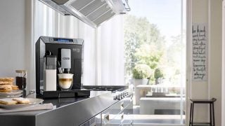DeLonghi Eletta Cappuccino Top machine making coffee in kitchen.