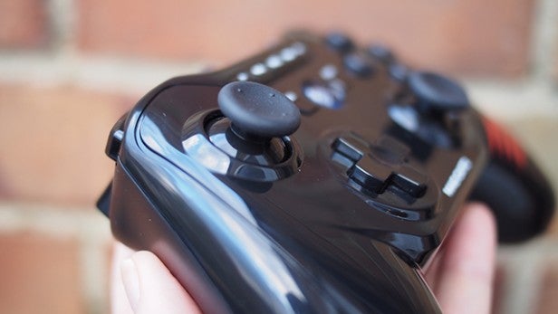 Close-up of a hand holding a Mad Catz C.T.R.L.R game controller.