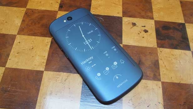 YotaPhone 2 showing e-ink display on a wooden surface.
