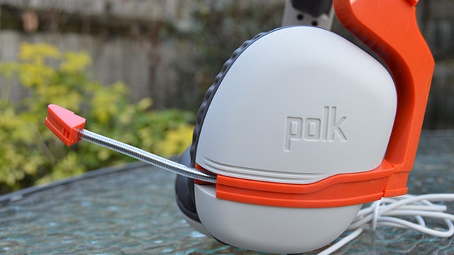 Polk Striker Zx gaming headset with microphone on glass table.