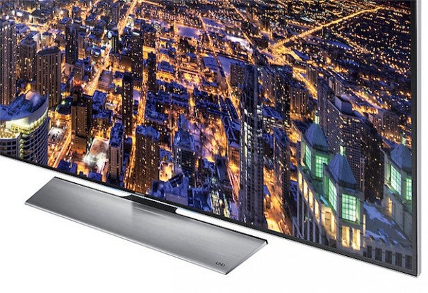Samsung UE85HU7500Flat screen TV displaying vibrant cityscape with external soundbar.