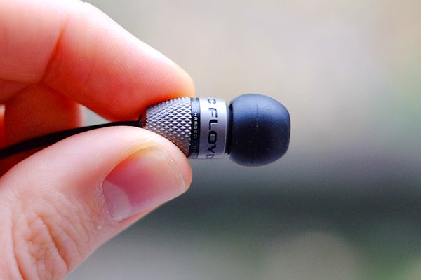 Close-up of Atomic Floyd SuperDarts Titanium earbud in hand.