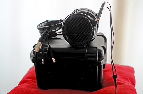 Audeze LCD-X headphones resting on a black case.