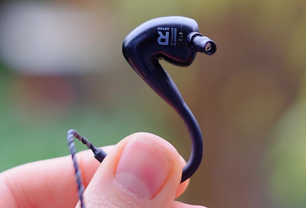 Close-up of Audiofly AF140 in-ear monitor held by fingers
