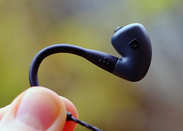 Close-up of Audiofly AF140 in-ear monitor held between fingers.