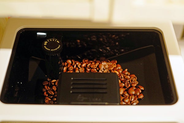 Close-up of DeLonghi Eletta Cappuccino Top coffee beans compartment.