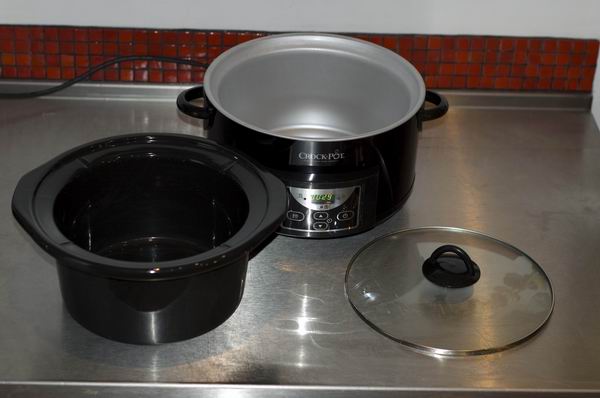 Crock-Pot slow cooker with lid and pot on kitchen counter.