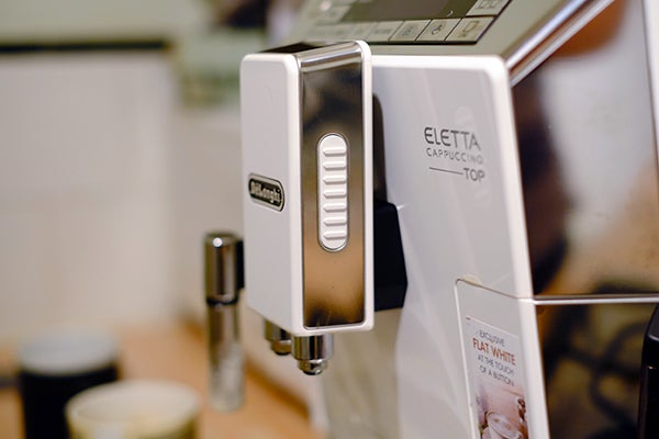 Close-up of DeLonghi Eletta Cappuccino Top espresso machine.
