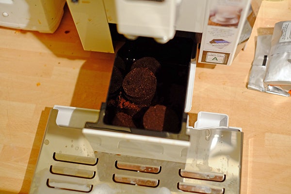 Used coffee pucks in DeLonghi Eletta machine tray.