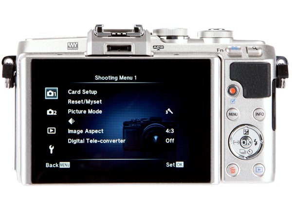 Olympus Pen E-PL7 camera with shooting menu displayed on screen.