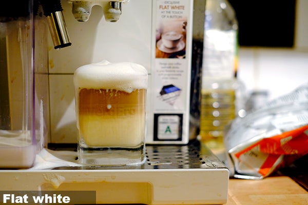 Freshly made flat white coffee in DeLonghi Eletta machine