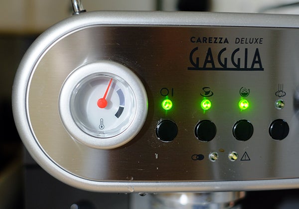 Close-up of Gaggia Carezza Deluxe espresso machine control panel.
