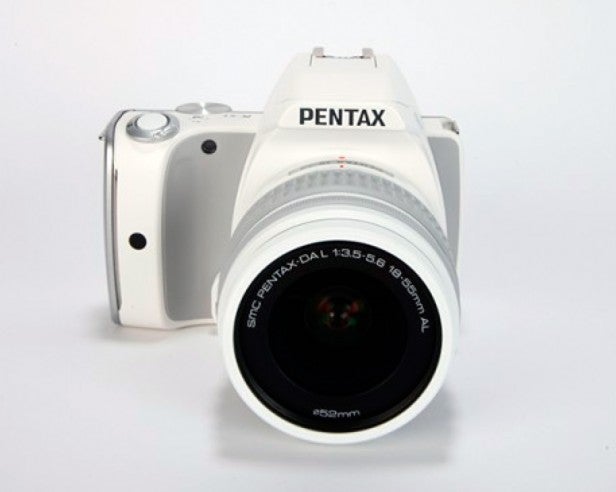 Pentax K-S1 DSLR camera with white 18-55mm lens.
