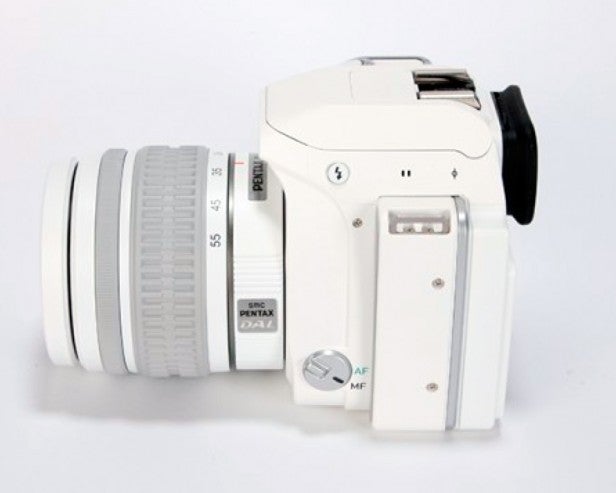 White DSLR camera with a lens and AF/MF switch.