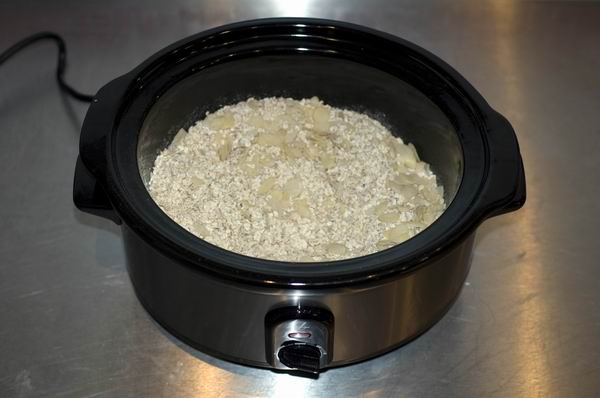 Lakeland slow cooker with oatmeal cooking on kitchen counter.