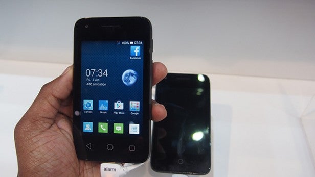 Two Alcatel OneTouch Pixi 3 smartphones on display at a store.Hand holding Alcatel OneTouch Pixi 3 smartphone with screen on.Hand holding Alcatel OneTouch Pixi 3 next to another device.
