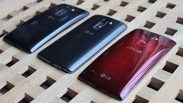 Three LG G Flex 2 smartphones in black and red colors.