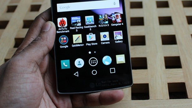 Hand holding LG G Flex 2 displaying home screen icons