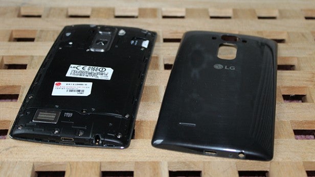 Dismantled smartphone showing battery and back cover.