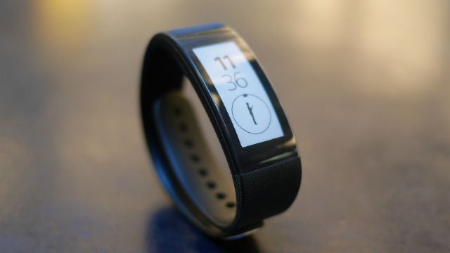 Sony SmartBand Talk on table displaying time and activity.