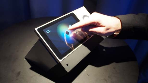 Person interacting with BeoSound Moment music interface.