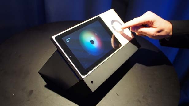 Person interacting with BeoSound Moment music interface.