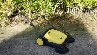 Karcher S650 manual outdoor sweeper on a driveway.