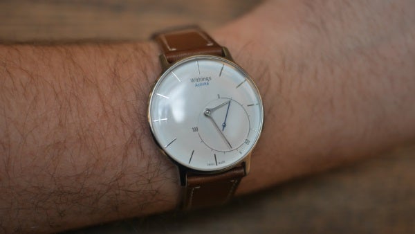 Withings Activité watch on a wrist with leather strap.