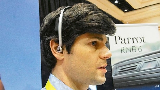 Tablet displaying Parrot Zik Sport app interface.Man wearing Parrot Zik Sport headphones at an event.