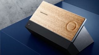 Bang & Olufsen BeoSound Moment on blue surface.