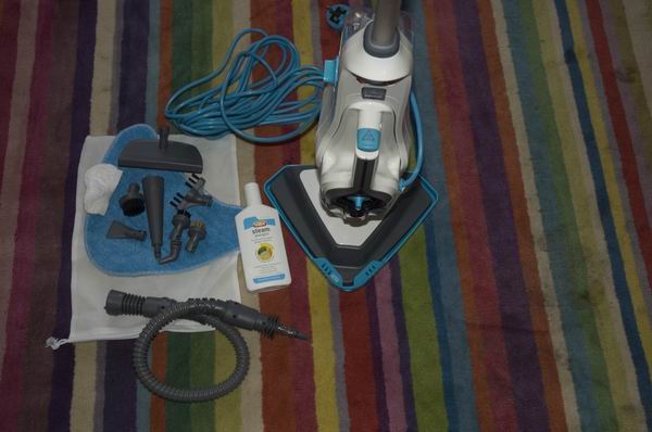 Vax Steam Fresh Combi S86-SF-C and accessories on a striped carpet.