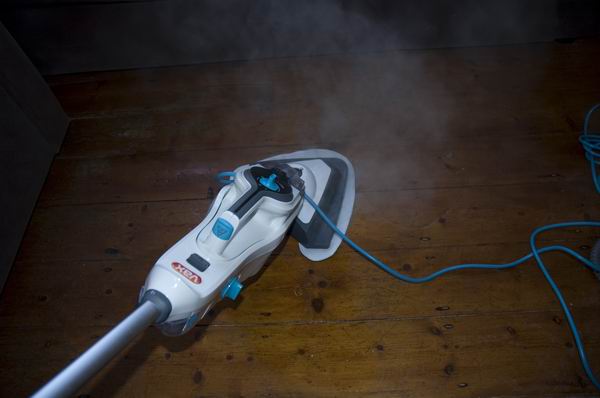 Vax Steam Fresh Combi steam cleaner in action on wooden floor.