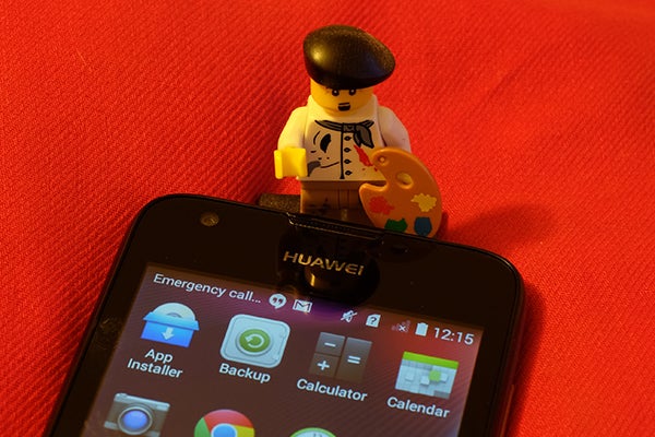 Lego artist figurine on Huawei Ascend Y550 smartphone.