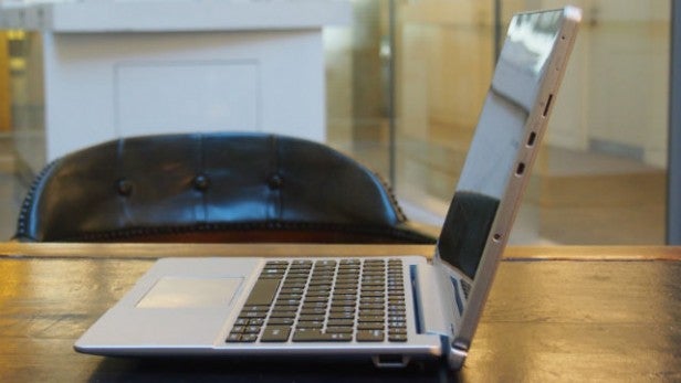 Side view of laptop showcasing slim design on a wooden table.