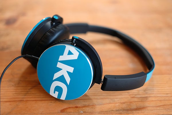 AKG Y50 headphones on wooden surface.