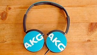 AKG Y50 headphones on wooden background.