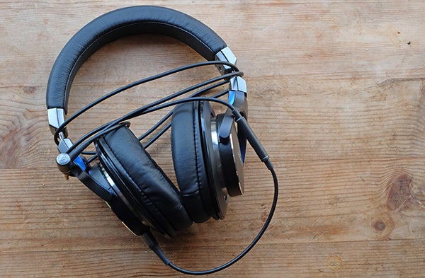 Audio-Technica ATH-MSR7 headphones on wooden surface.