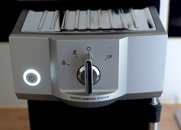 Krups XP5620 espresso machine with tamping system and controls.