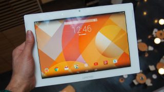 Hand holding Aldi Medion Lifetab S10346 tablet with screen on.