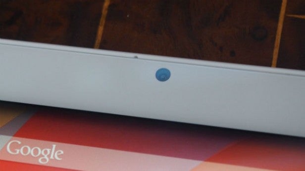 Close-up of a laptop camera above a screen displaying a Google logo.