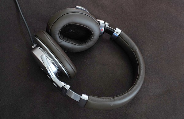 Sony MDR-1A headphones on a dark fabric surface.