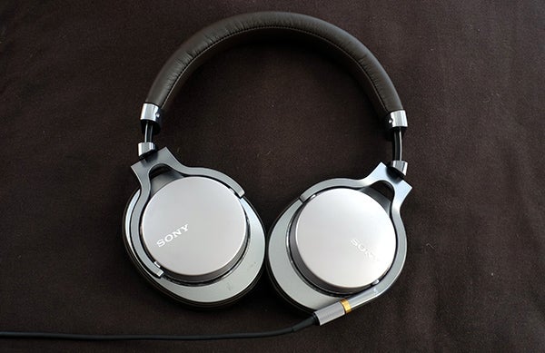 Sony MDR-1A headphones on a brown background.