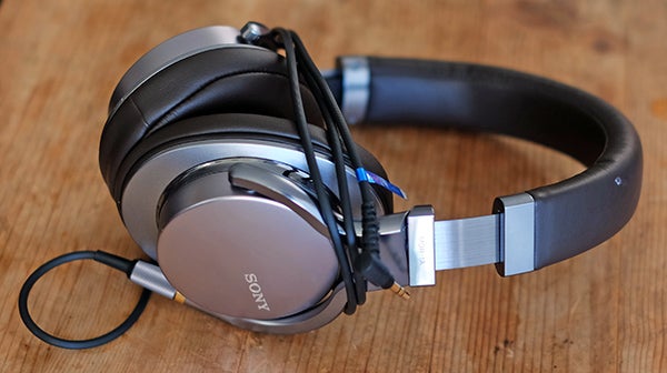 Sony MDR-1A headphones on a wooden surface.