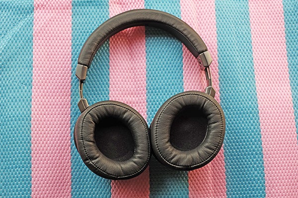 Audio-Technica ATH-MSR7 headphones on striped pink and blue fabric.