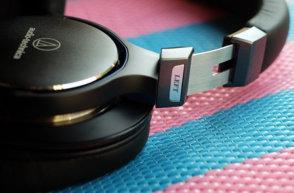 Close-up of Audio-Technica ATH-MSR7 headphone on textured surface.