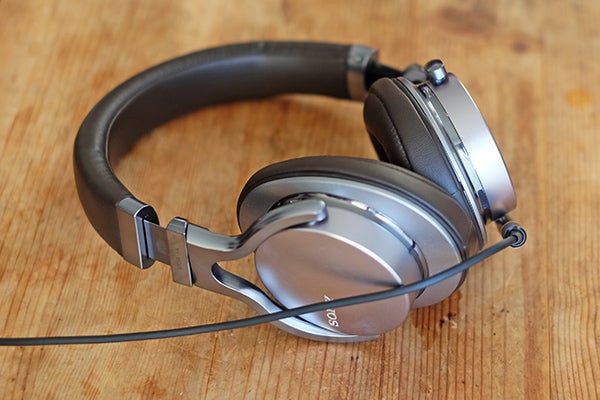 Sony MDR-1A headphones on a wooden surface.