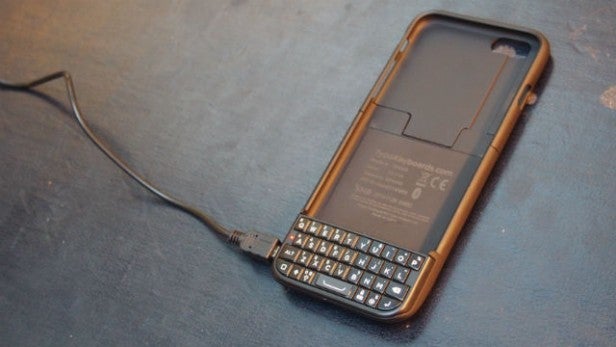 Typo 2 keyboard case for iPhone 6 connected to USB cable.